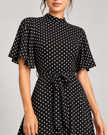 Black dress, neckline, flutter sleeve, polka-dot fabric and waist tie details