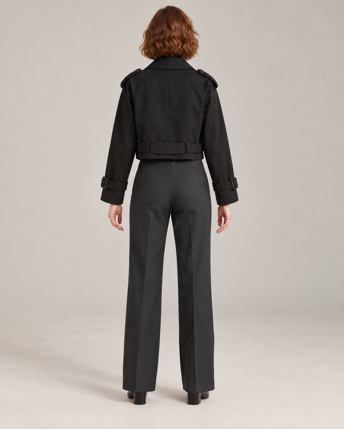 Black trench-style jacket, full-length direct rear view