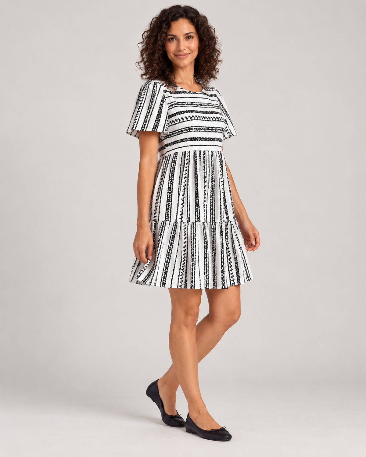 Full-length three-quarter view of the Black variant of the Women's Striped Round-Neck Tiered Dress
