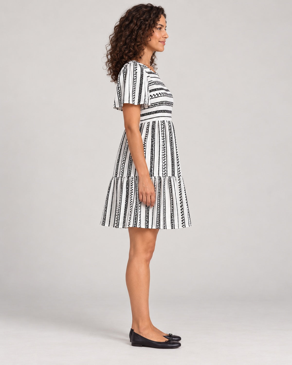 Full-length side view of the Black variant of the Women's Striped Round-Neck Tiered Dress